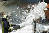 عکس استوک باکیفیت آتش نشان درحال خاموش کردن آتش